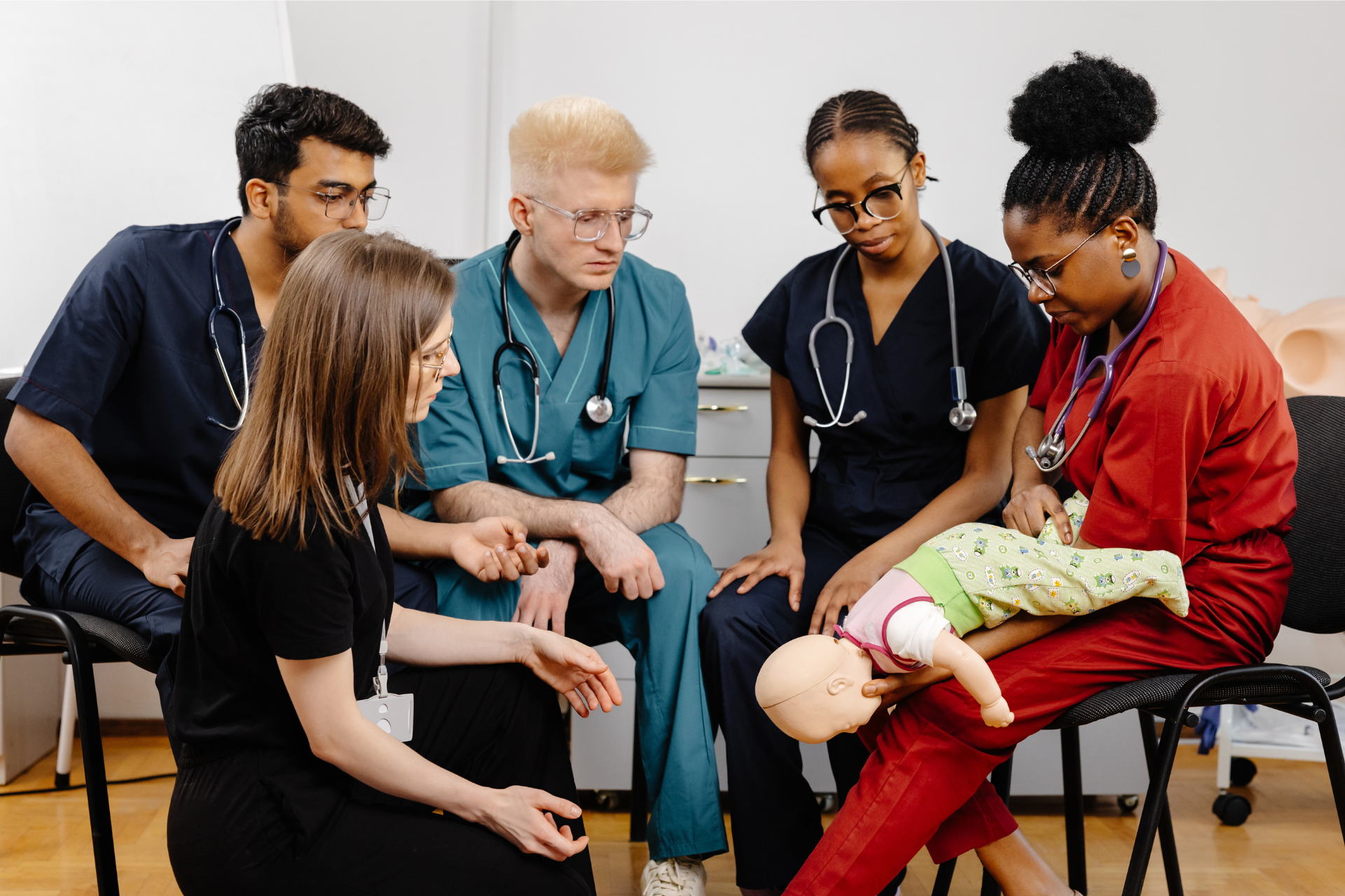 group-of-doctors-sitting-together-with-baby-manneq-2025-02-12-03-27-31-utc-1